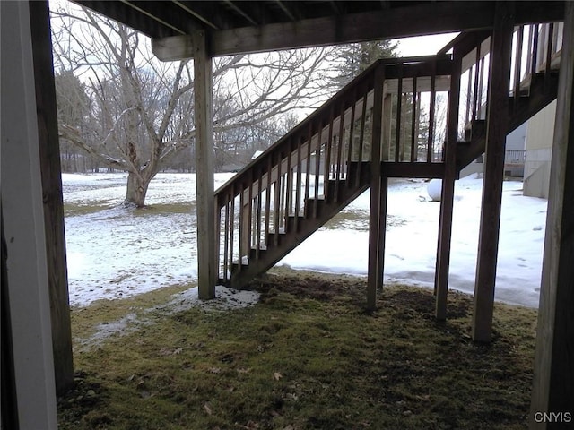 snow covered deck featuring stairs