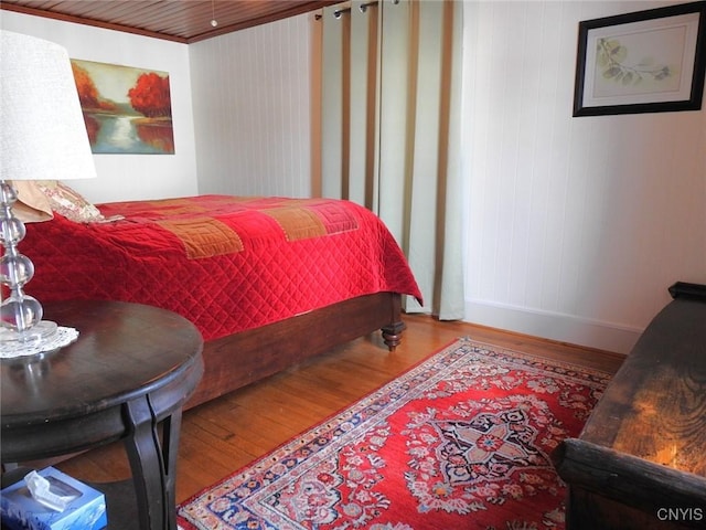 bedroom featuring baseboards and wood finished floors