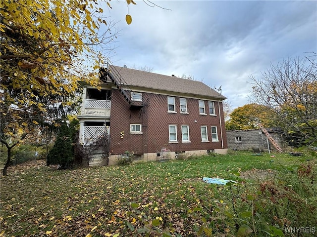 view of property exterior with a balcony and a yard