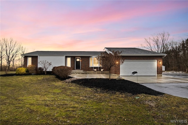 6741 Cole Rd, Orchard Park, NY 14127 - single story home with a front yard, brick siding, concrete driveway, and a garage