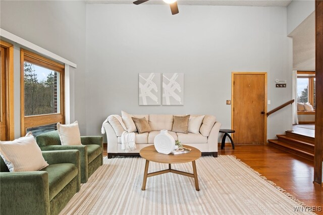 6741 Cole Rd, Orchard Park, NY 14127 - living room with a high ceiling, stairway, a ceiling fan, and wood finished floors