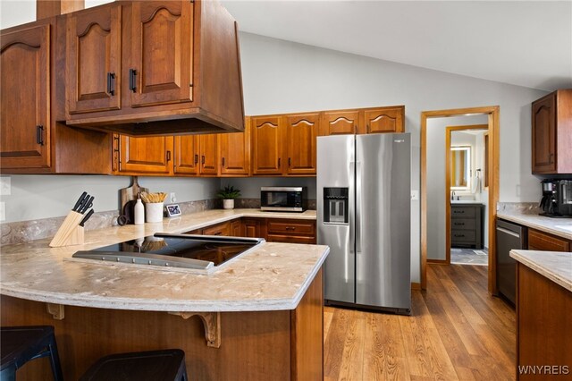 6741 Cole Rd, Orchard Park, NY 14127 - kitchen with light countertops, a peninsula, stainless steel appliances, and lofted ceiling
