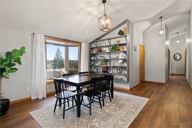 6741 Cole Rd, Orchard Park, NY 14127 - dining space with hardwood / wood-style flooring, baseboards, vaulted ceiling, and a textured ceiling