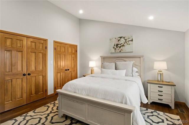 6741 Cole Rd, Orchard Park, NY 14127 - bedroom with vaulted ceiling, wood finished floors, multiple closets, visible vents, and recessed lighting