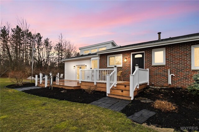 6741 Cole Rd, Orchard Park, NY 14127 - view of front of house with a front yard, a deck, and brick siding