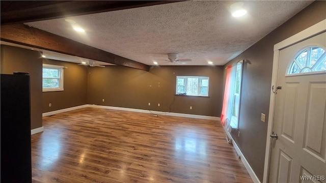 entryway featuring a textured ceiling, wood finished floors, and a ceiling fan