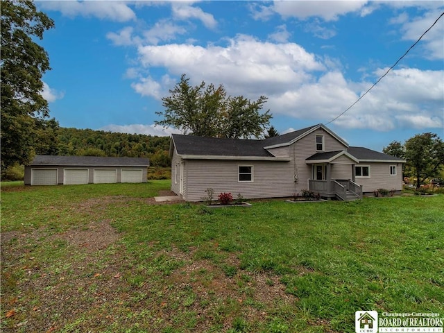 673 Ivory Rd, Carroll, NY 14738 - rear view of house with a lawn, a detached garage, and an outbuilding