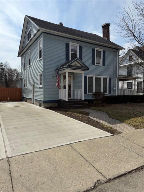 507 W Hudson St, Elmira-City, NY 14904 - view of front of property with driveway, fence, and a chimney
