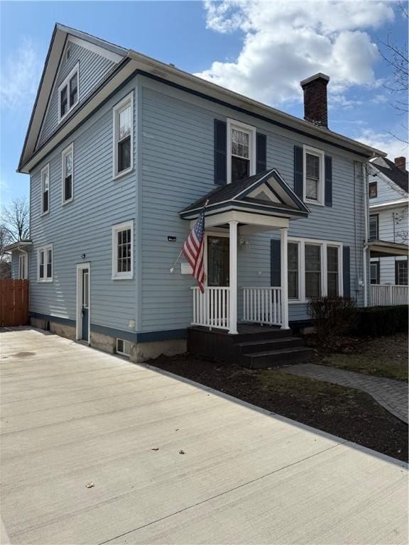 507 W Hudson St, Elmira-City, NY 14904 - view of front of house featuring a porch, fence, and a chimney
