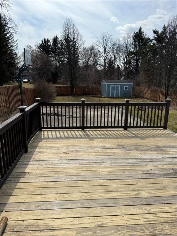 507 W Hudson St, Elmira-City, NY 14904 - wooden terrace featuring an outdoor structure, a fenced backyard, and a storage unit