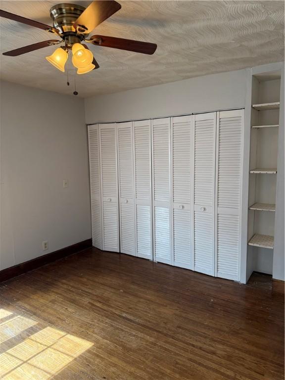 507 W Hudson St, Elmira-City, NY 14904 - unfurnished bedroom featuring baseboards, wood finished floors, ceiling fan, and a textured ceiling