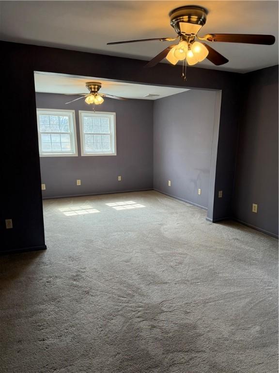 507 W Hudson St, Elmira-City, NY 14904 - carpeted empty room featuring baseboards, visible vents, and a ceiling fan
