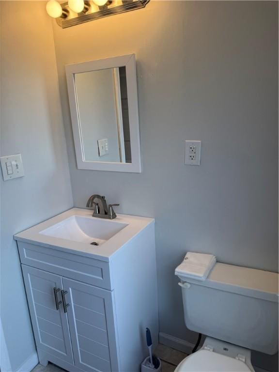 507 W Hudson St, Elmira-City, NY 14904 - bathroom featuring baseboards, toilet, and vanity