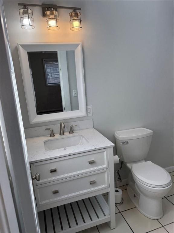 507 W Hudson St, Elmira-City, NY 14904 - half bathroom with tile patterned floors, toilet, baseboards, and vanity