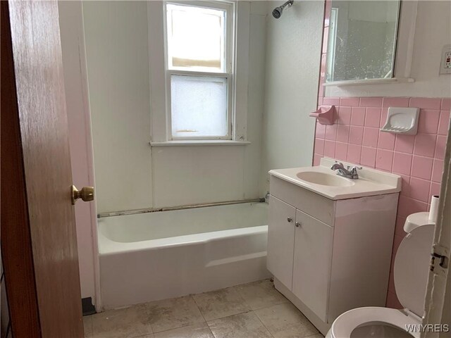 49 Newburgh Ave, Buffalo, NY 14211 - full bathroom featuring toilet, vanity, tile patterned floors, and tile walls