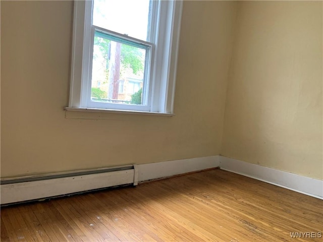 49 Newburgh Ave, Buffalo, NY 14211 - unfurnished room with a baseboard heating unit, wood-type flooring, and baseboards