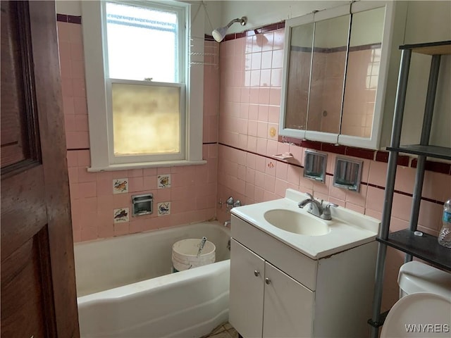 49 Newburgh Ave, Buffalo, NY 14211 - bathroom featuring a tub, toilet, vanity, tasteful backsplash, and tile walls