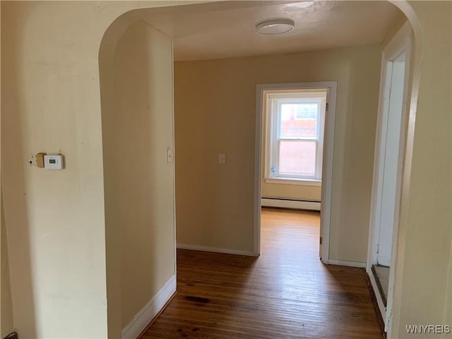 49 Newburgh Ave, Buffalo, NY 14211 - corridor featuring a baseboard radiator, arched walkways, wood finished floors, and baseboards