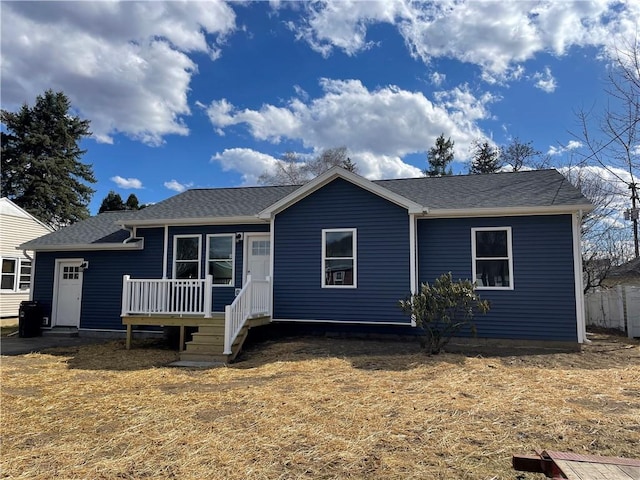 view of front of home featuring a shingled roof and a wooden deck