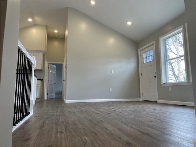 entryway featuring dark wood-style flooring, high vaulted ceiling, baseboards, and recessed lighting