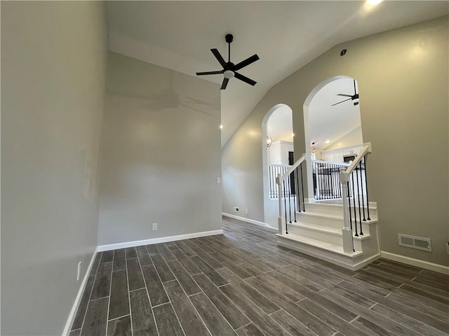 unfurnished room featuring wood tiled floor, visible vents, lofted ceiling, and ceiling fan