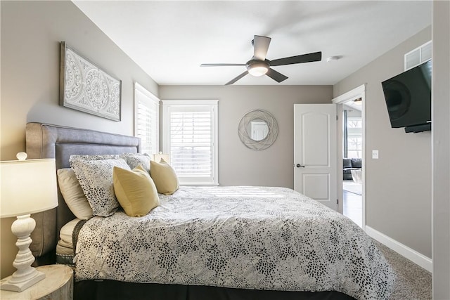 5027 Wyffels Rd, Canandaigua-Town, NY 14424 - carpeted bedroom with a ceiling fan, baseboards, and multiple windows