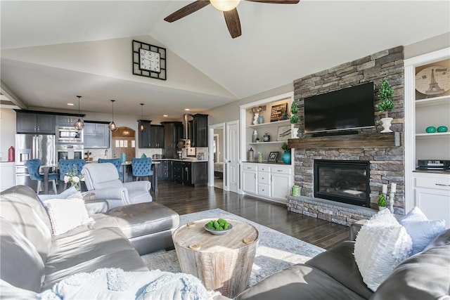 5027 Wyffels Rd, Canandaigua-Town, NY 14424 - living area with dark wood-style flooring, ceiling fan, a stone fireplace, and lofted ceiling