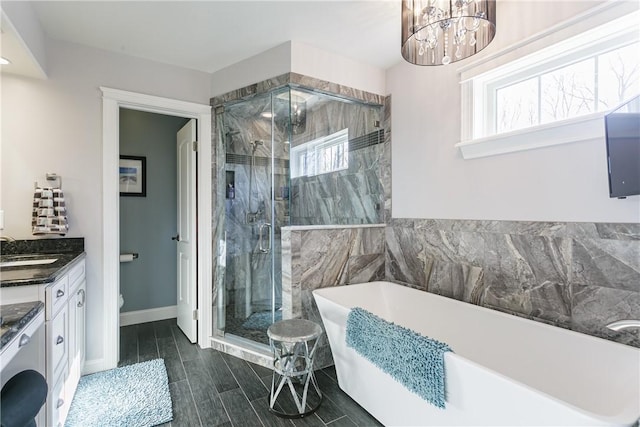 5027 Wyffels Rd, Canandaigua-Town, NY 14424 - full bathroom featuring a freestanding bath, washer / clothes dryer, a stall shower, and a healthy amount of sunlight