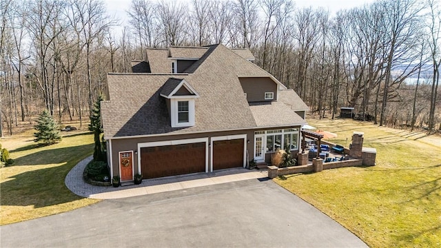 5027 Wyffels Rd, Canandaigua-Town, NY 14424 - view of front facade featuring driveway, a front lawn, roof with shingles, and a garage