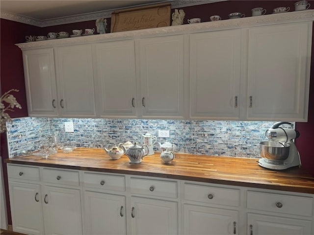 612 Oswegatchie Rd, Palatine, NY 13428 - kitchen with butcher block countertops, tasteful backsplash, and white cabinets