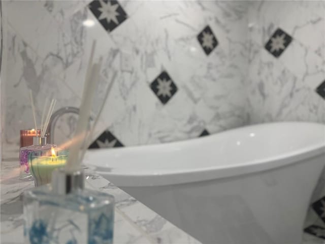 612 Oswegatchie Rd, Palatine, NY 13428 - bathroom with marble tiled floors and a soaking tub