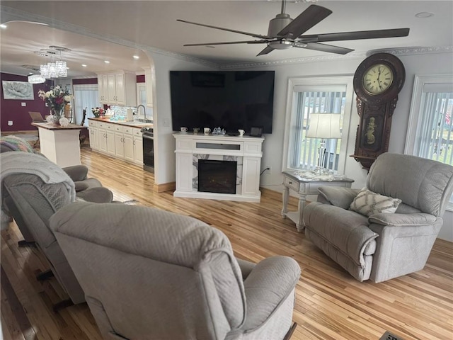 612 Oswegatchie Rd, Palatine, NY 13428 - living room featuring a ceiling fan, a chandelier, light wood-type flooring, crown molding, and recessed lighting