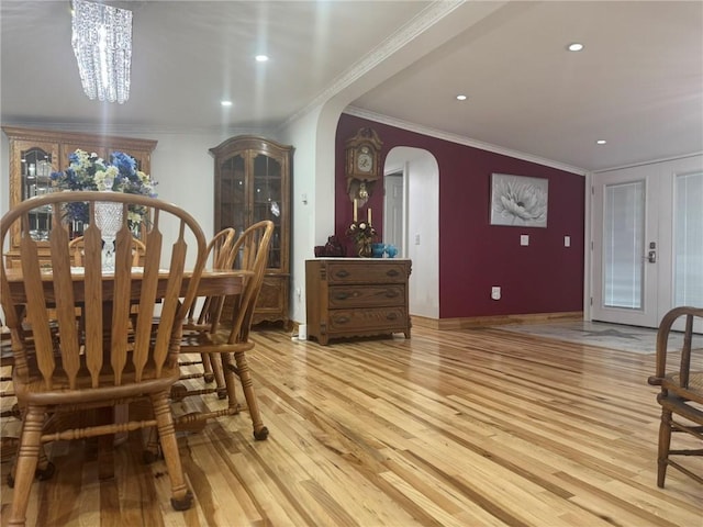 612 Oswegatchie Rd, Palatine, NY 13428 - dining space featuring arched walkways, light wood finished floors, ornamental molding, a chandelier, and french doors