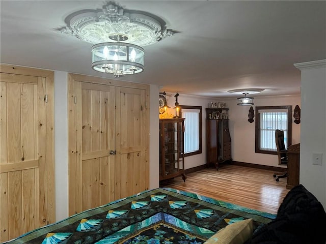 612 Oswegatchie Rd, Palatine, NY 13428 - bedroom featuring wood finished floors, baseboards, and a chandelier