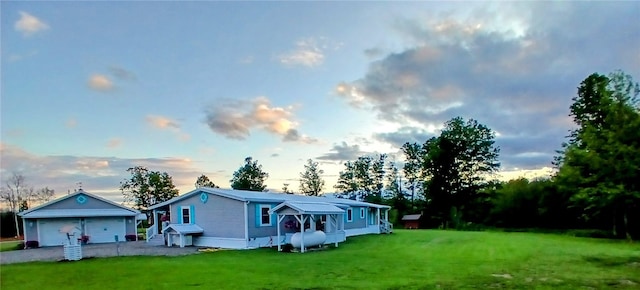 612 Oswegatchie Rd, Palatine, NY 13428 - back of property at dusk featuring a garage and a yard