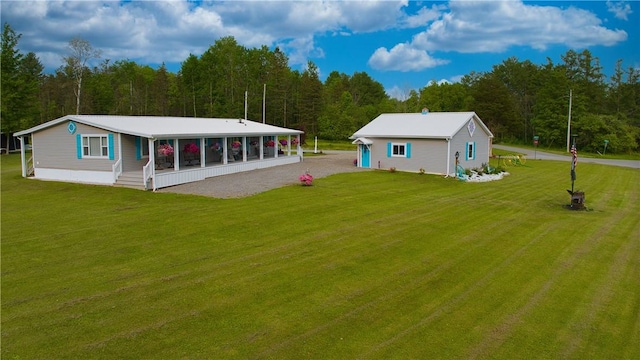612 Oswegatchie Rd, Palatine, NY 13428 - rear view of property with a lawn, covered porch, gravel driveway, and a forest view