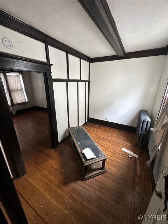 additional living space with beamed ceiling, baseboards, and wood finished floors