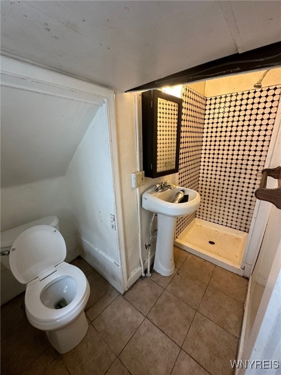 bathroom with tile patterned floors, a shower stall, and toilet
