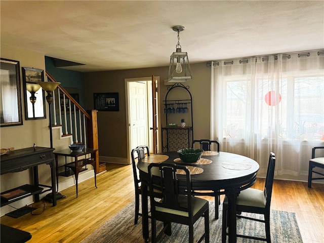 605 Watkins Rd, Horseheads, NY 14845 - dining space featuring baseboards, light wood-style floors, and stairway
