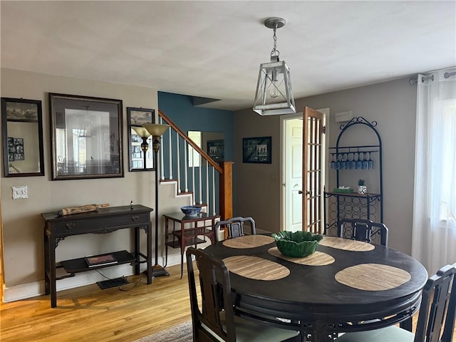 605 Watkins Rd, Horseheads, NY 14845 - dining area featuring stairs, light wood-style floors, and baseboards