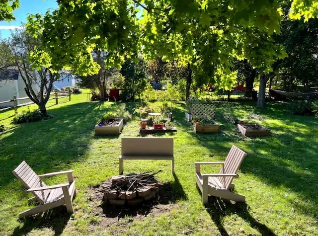 605 Watkins Rd, Horseheads, NY 14845 - surrounding community featuring a vegetable garden, a fire pit, fence, and a lawn