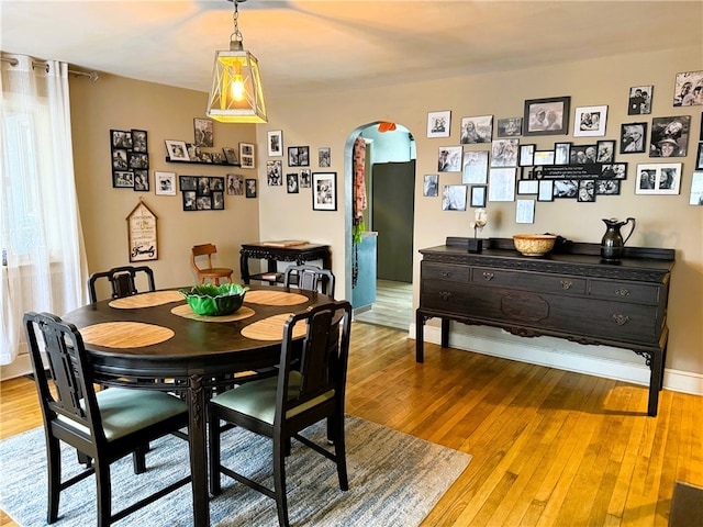 605 Watkins Rd, Horseheads, NY 14845 - dining room with arched walkways, hardwood / wood-style flooring, and baseboards
