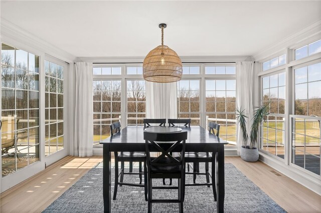 sunroom with visible vents and a wealth of natural light