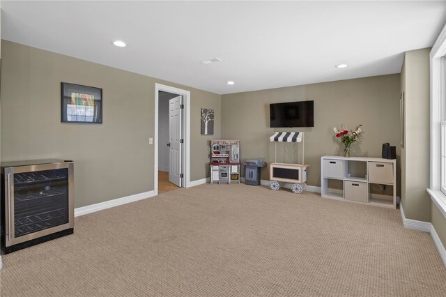 playroom featuring wine cooler, recessed lighting, and carpet floors