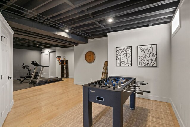 rec room featuring wood finished floors and baseboards