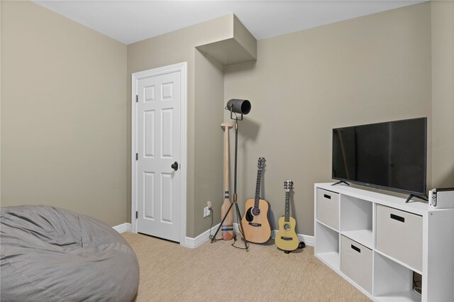 recreation room with baseboards and carpet floors