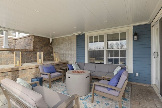 view of patio / terrace featuring an outdoor living space with a fire pit