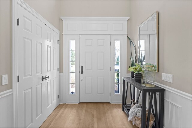 entryway featuring a wainscoted wall and light wood-style floors