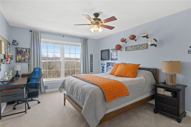 carpeted bedroom with baseboards and a ceiling fan