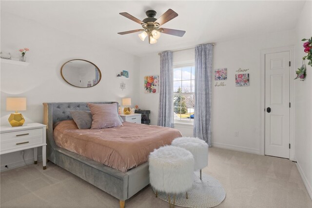 bedroom with baseboards, ceiling fan, and light colored carpet